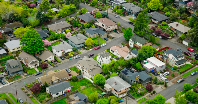 Aerial view of a tree-lined single-family residential neighborhood in Portland, Oregon – representative of homes now eligible for 2026 FHA loan limits up to $806,500