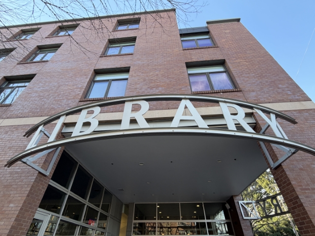 Hollywood Library entrance in Northeast Portland – January 12, 2026, showing modern brick building and curved glass canopy.