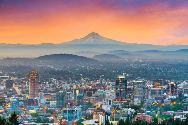 Image of Portland downtown area at dusk with Mt. Hood in the background.